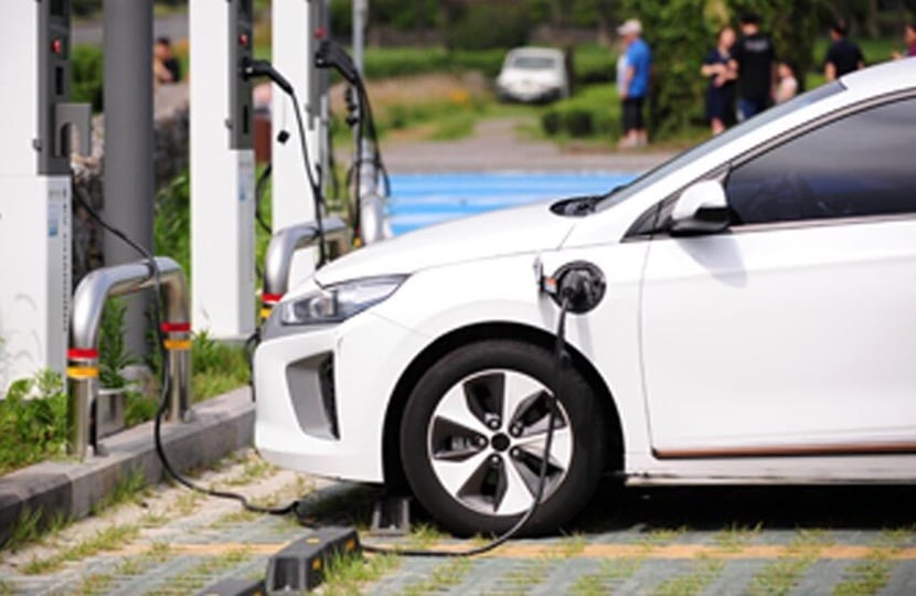 person standing in front of a car with a clipboard and pen