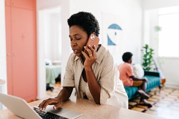 person on the phone cancelling their car insurance