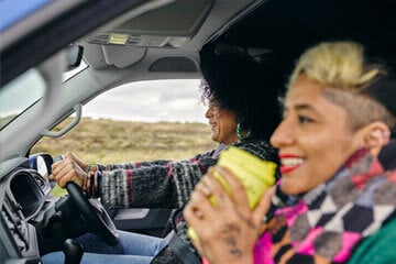 Driver and passenger in the front seats of a car