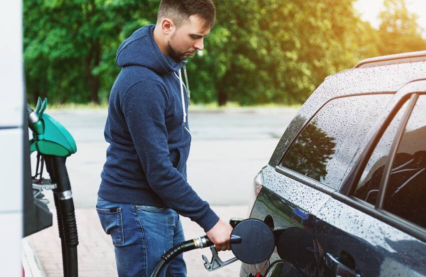 person putting fuel in their car