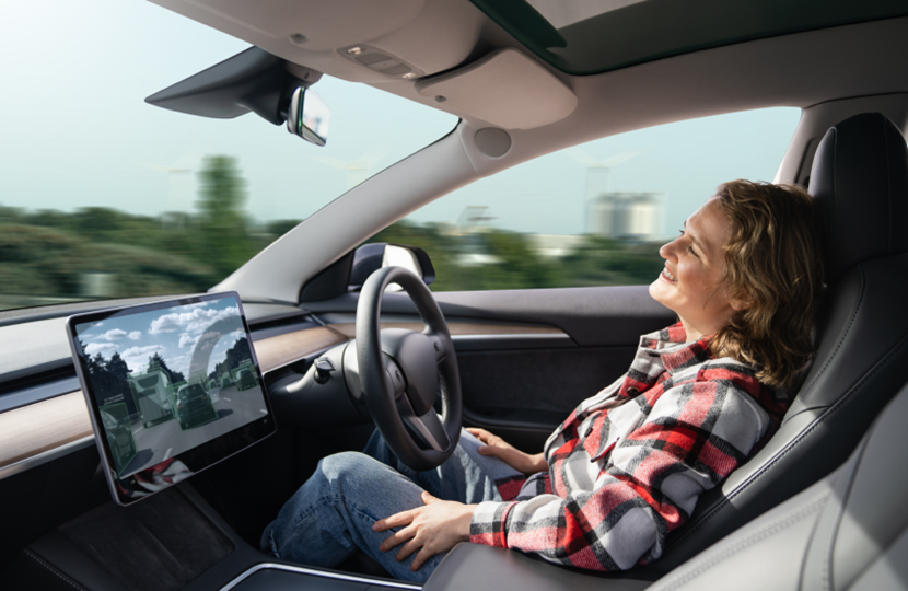 person sat in autonomous car