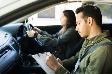 Examiner and learner in a car on a driving test