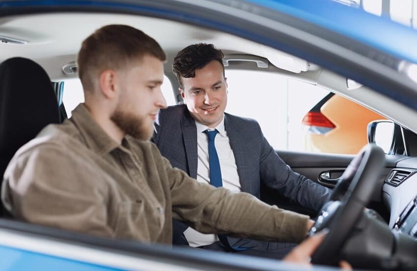 person standing in front of a car with a clipboard and pen