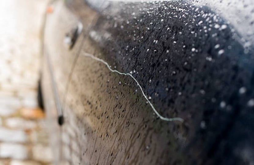 car door with a key scratch mark