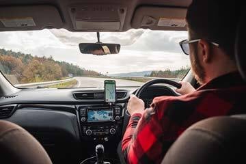 person driving a car on a mountain road