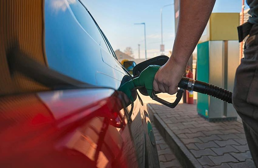 Someone filling up their car at a petrol pump