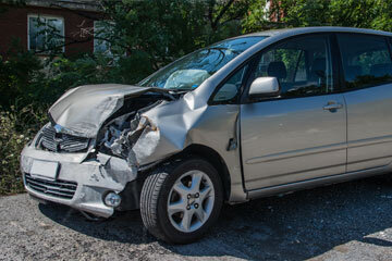 Badly damaged car with crumpled bonnet