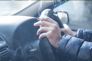 person smoking while driving