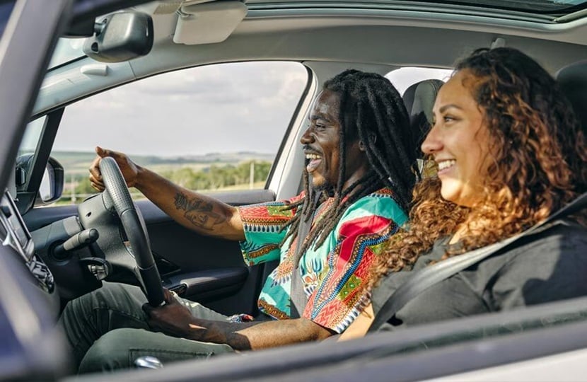 Side view of a driver and passenger in a car