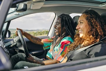 Side view of a driver and a passenger in the front of a car