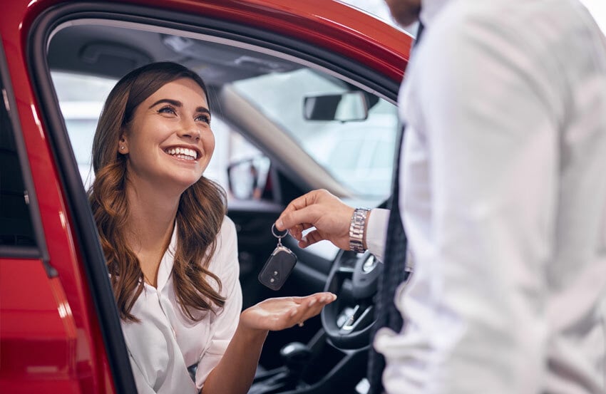 Car dealer handing keys to a buyer