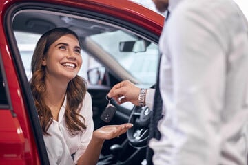 Car buyer receiving keys from a dealer