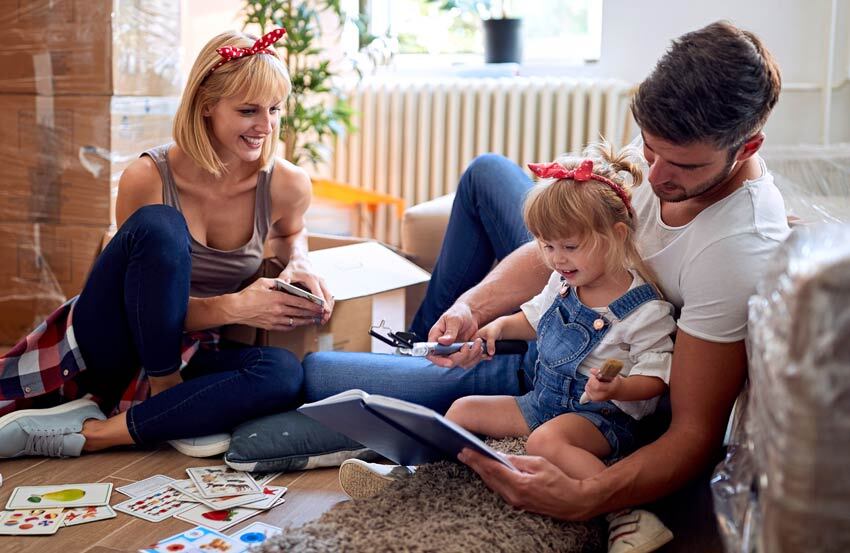 Family who have just moving looking at a book