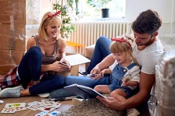 Family who have just moved looking at a book