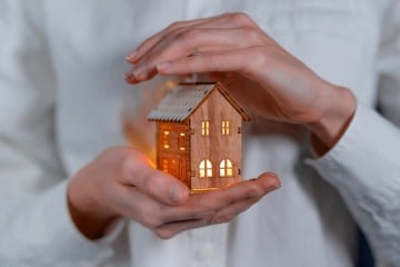 House held in human hands 