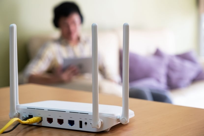 Wi-Fi router on table with man in the background 