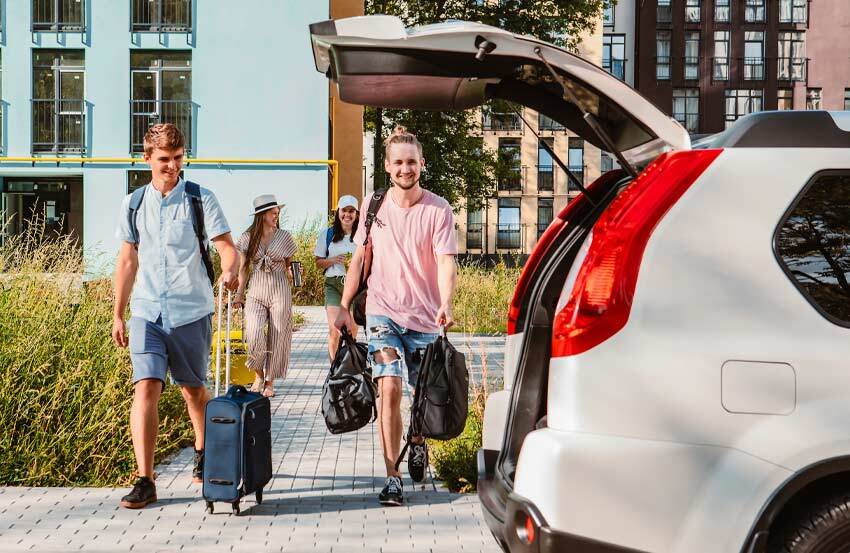 people walking towards a hire car