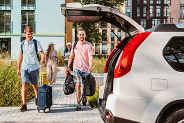 people walking towards a hire car