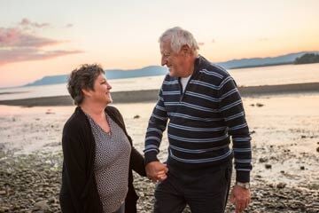 couple holding hands on a beach