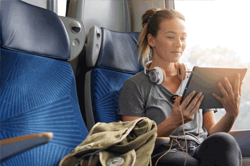 Woman on a plane holding a tablet