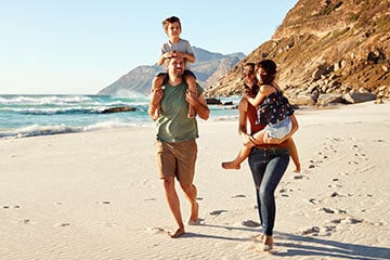 family walking on the beach