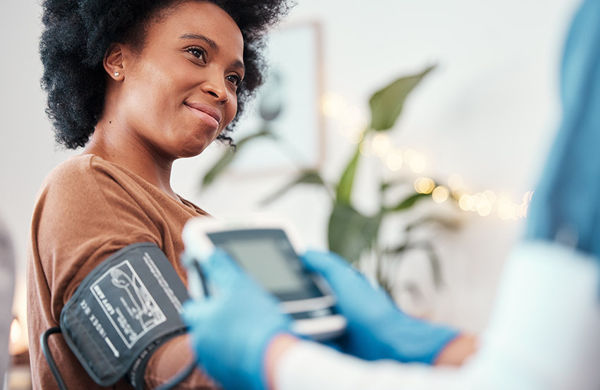 Lady having her blood pressure taken by a doctor