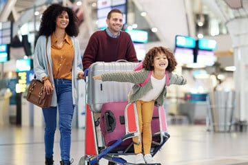 family walking through an airport