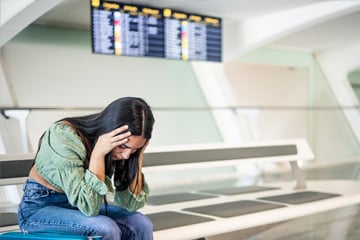 Person stressed at the airport because of a missed flight