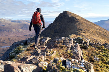 person walking up a mountain