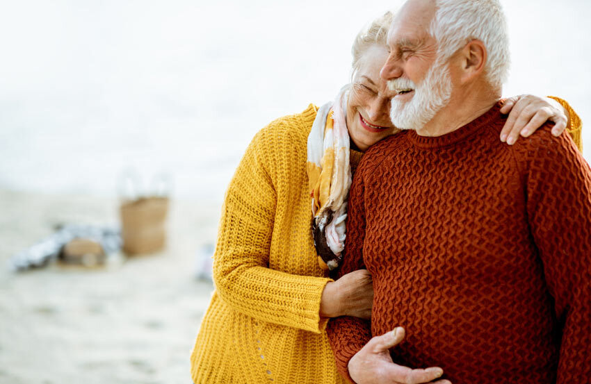 man and woman hugging each other on a beach