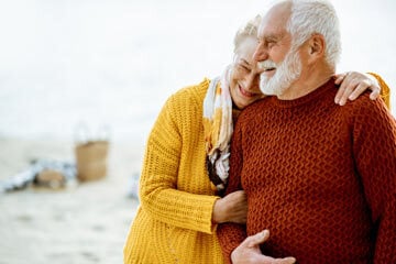 man and woman hugging after recovering from a stroke