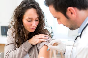 Woman receiving a vaccination.