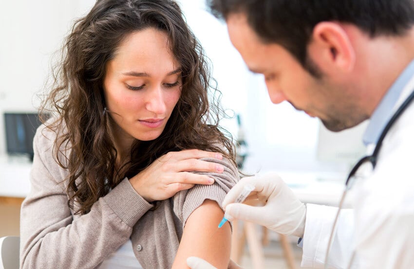 Woman receiving a vaccination.