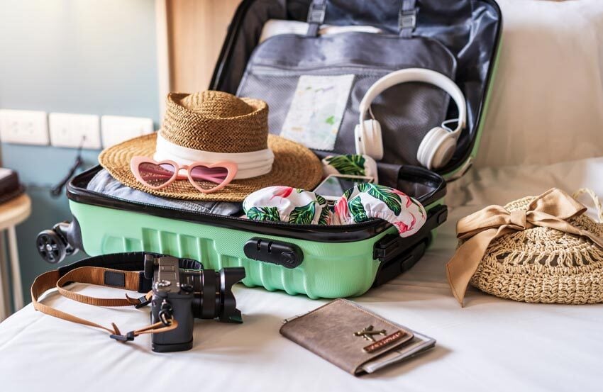 Items in a suitcase on a bed.