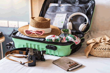 Items in a suitcase on a bed.