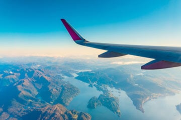 aeroplane flying over mountains and the sea