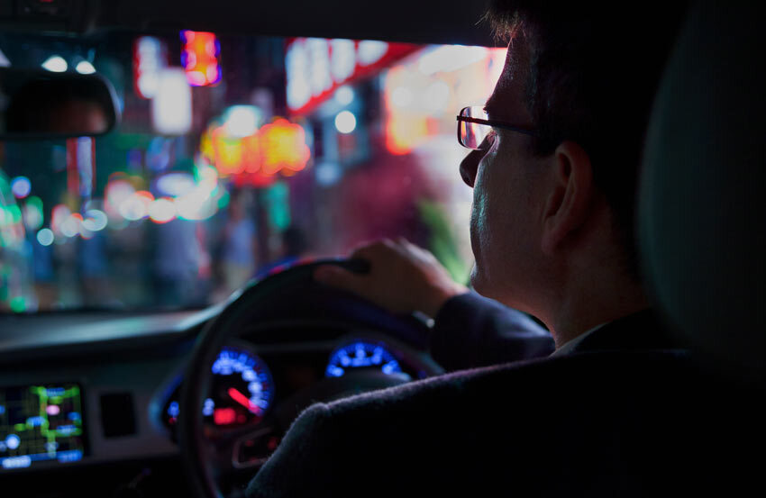 Man driving a car in the dark